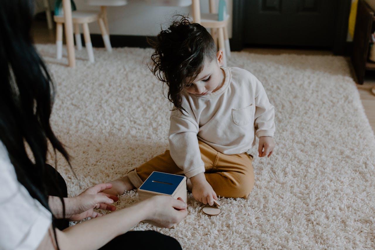 A child engages with an educational wooden toy on a soft carpet indoors, showcasing creativity and learning.